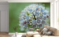 Beige sofa with chevron cushions beside a big blue allium bloom wall mural GD14202
