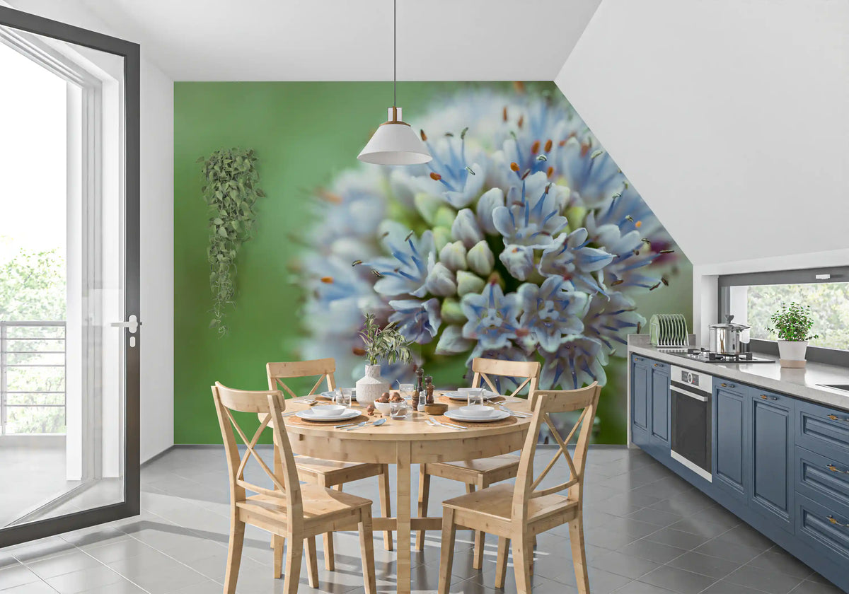 Kitchen dining nook with a round wood table and navy cabinets on floral wallpaper GD14202