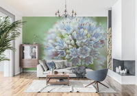 Floral wallpaper mural of a blue allium behind a light sofa and gray swivel chair GD14202