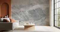 Gray sofa with rust cushions by a terracotta arch on a gray marble slab wall GD14203