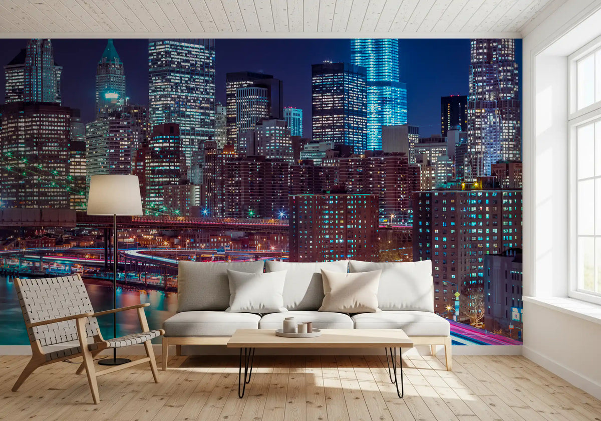 Cream sofa and woven wood armchair on light floors before a Manhattan night mural GD14205