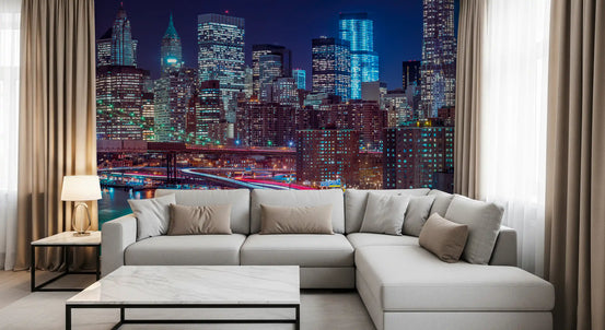 New York wallpaper mural behind a gray sectional, marble coffee table and curtains GD14205