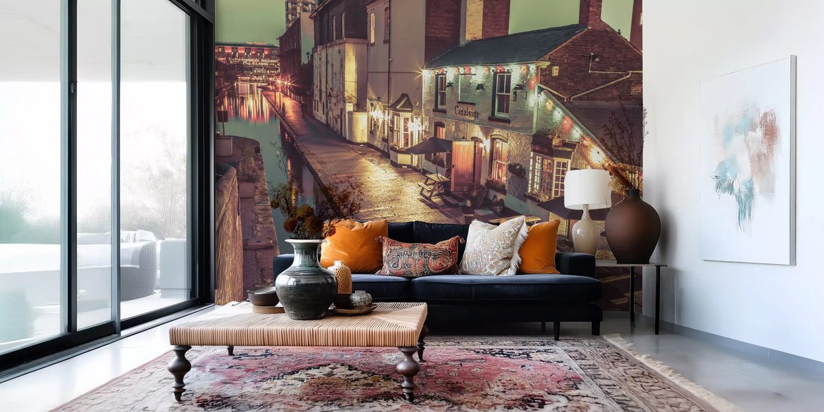 City wallpaper behind a navy velvet sofa, orange cushions and Persian rug GD14208