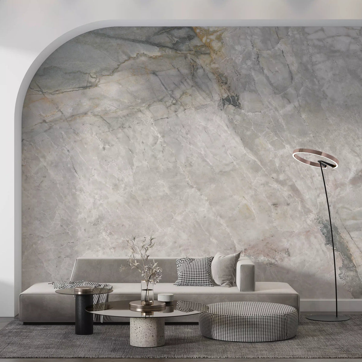 Marble wallpaper under a white arch behind a low gray sofa and houndstooth pouf GD14211