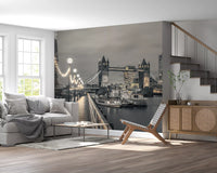 Riverside lights mural behind a gray sofa and sling chair near a wooden staircase GD14214