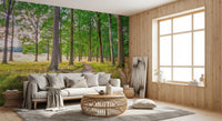 Beige sofa with rattan table beside a wood panel wall and tall window on forest wallpaper GD14219