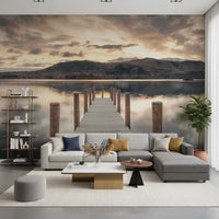 Gray corner sofa, open shelving and white coffee table under lake wallpaper with a golden sky GD14220