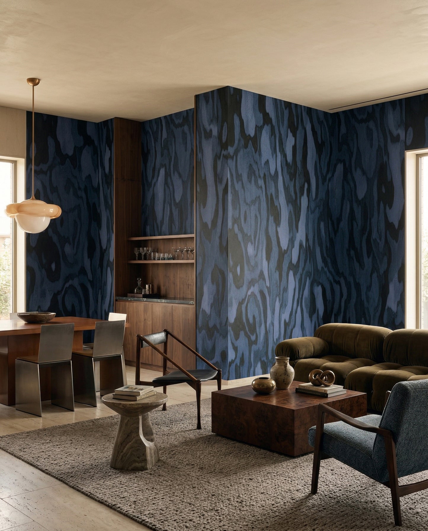Living room mood holds deep indigo grain from the Ettore wall mural.