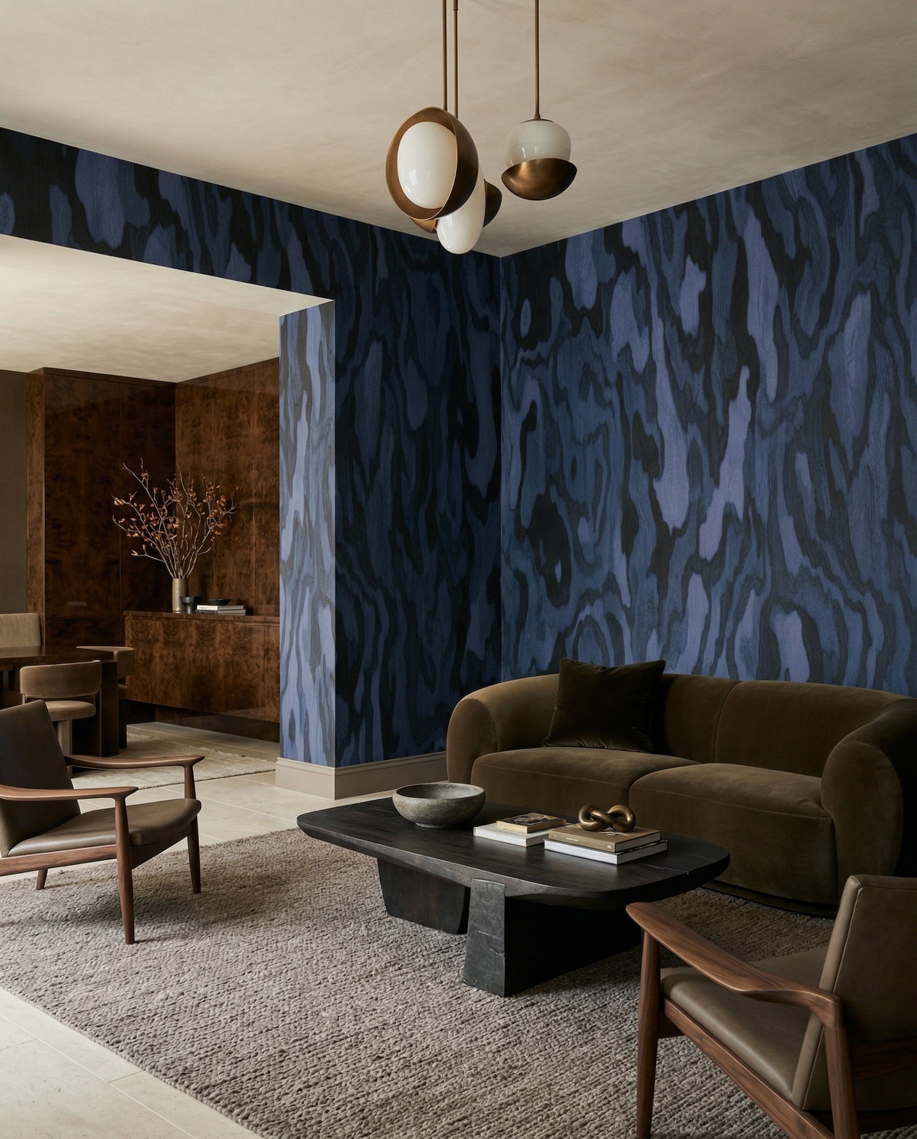 The Ettore Burl wall mural pours indigo burr-wood grain into a living room.