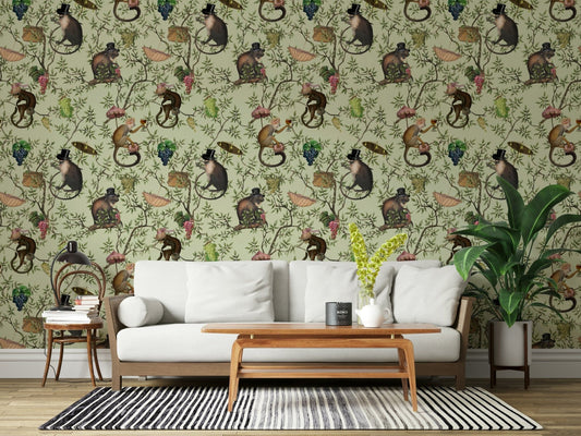 A Primate's Afternoon Tea green wallpaper behind a white wood-frame sofa with a striped rug and plant