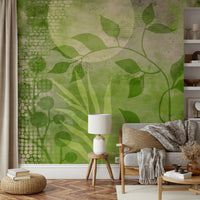 Green and beige mural wallpaper with soft plant shapes


