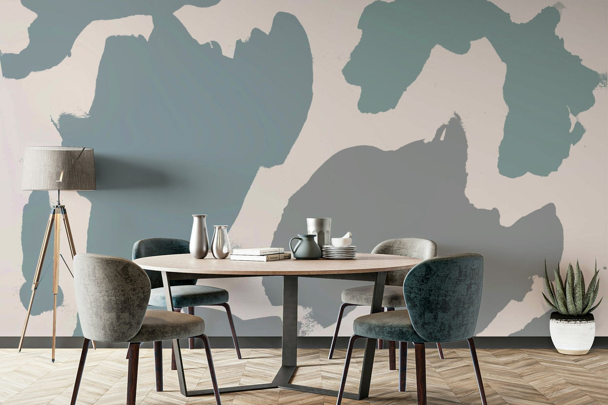 Abstract Shores wallpaper mural with blue and teal organic shapes in a dining room with a round table and velvet chairs