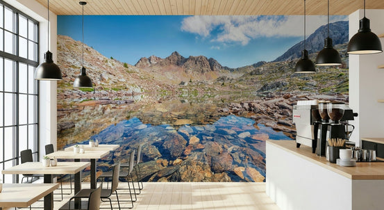 Alpine Serenity wallpaper mural of a rocky mountain lake behind small cafe tables and an espresso counter