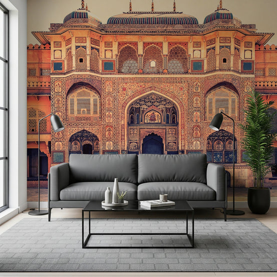 Amber Palace Grandeur wallpaper mural of an ornate amber Indian palace facade behind a gray sofa in a living room