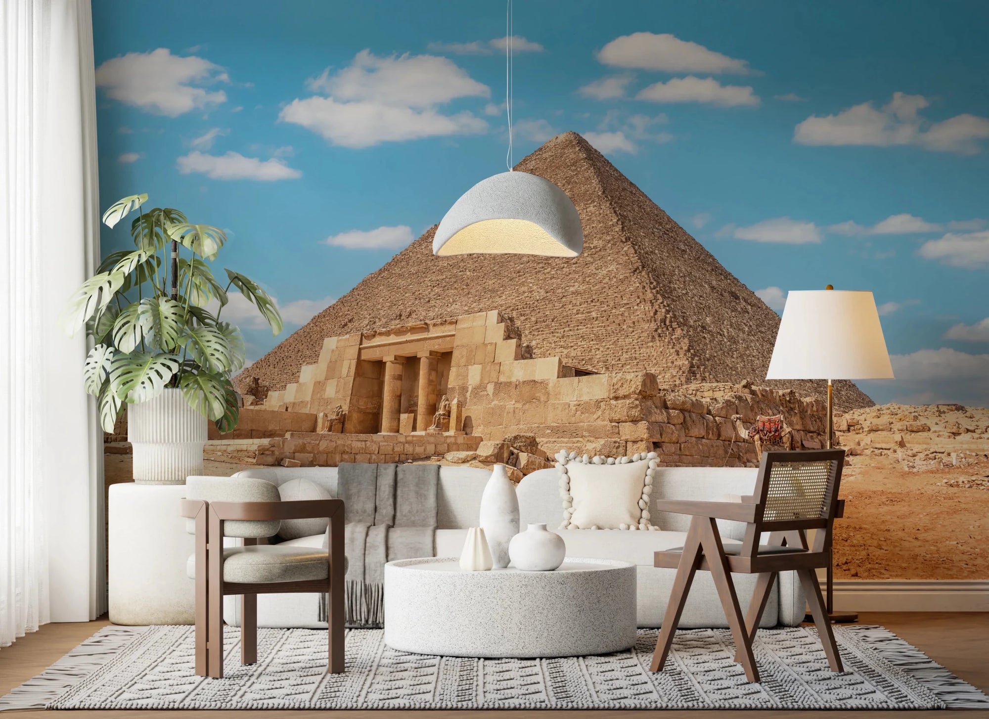 Ancient Wonders wallpaper mural of the Great Pyramid and temple behind a white sofa with cane accent chairs
