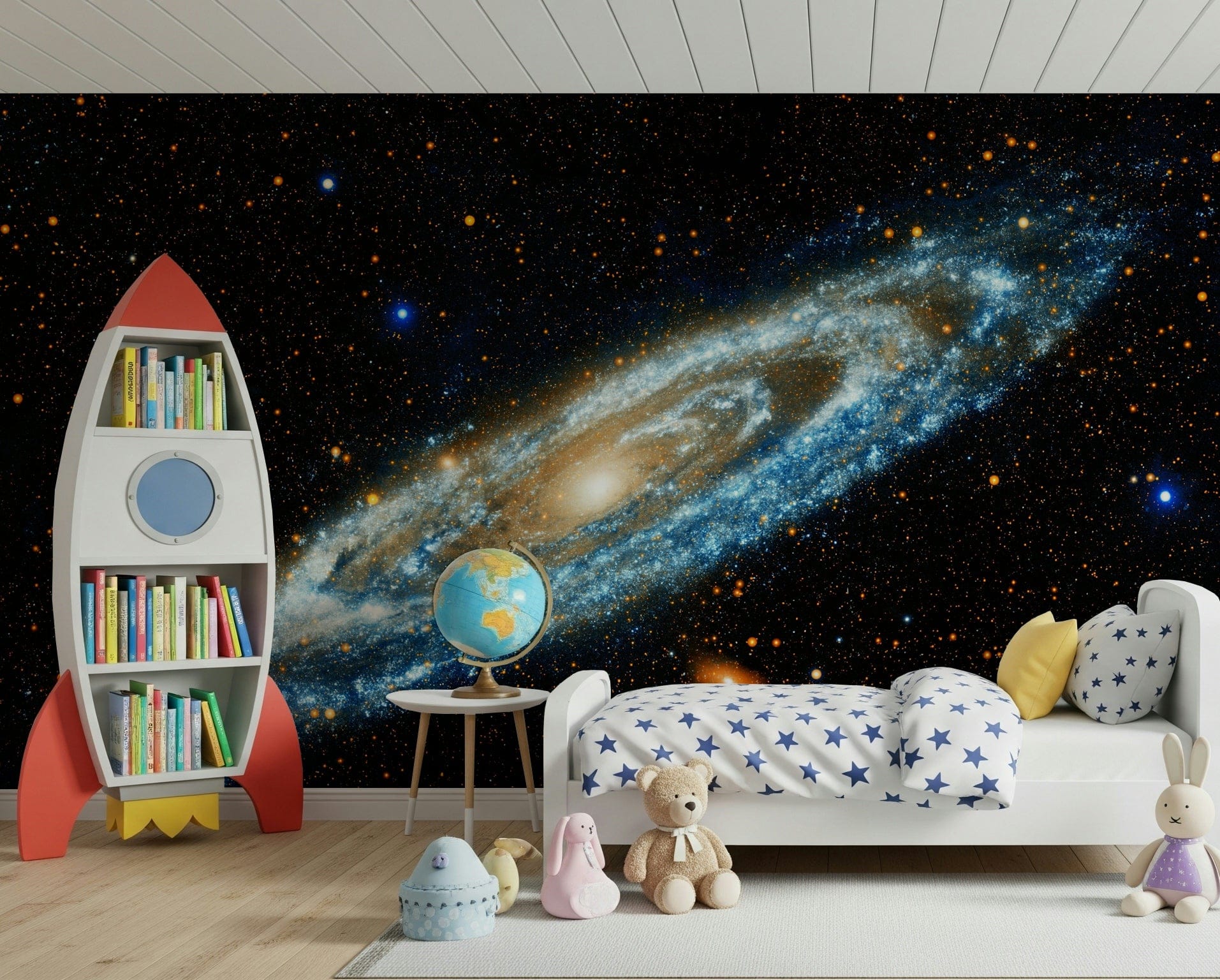 Andromeda mural of a blue spiral galaxy on black behind a star-print kids bed and red rocket bookshelf