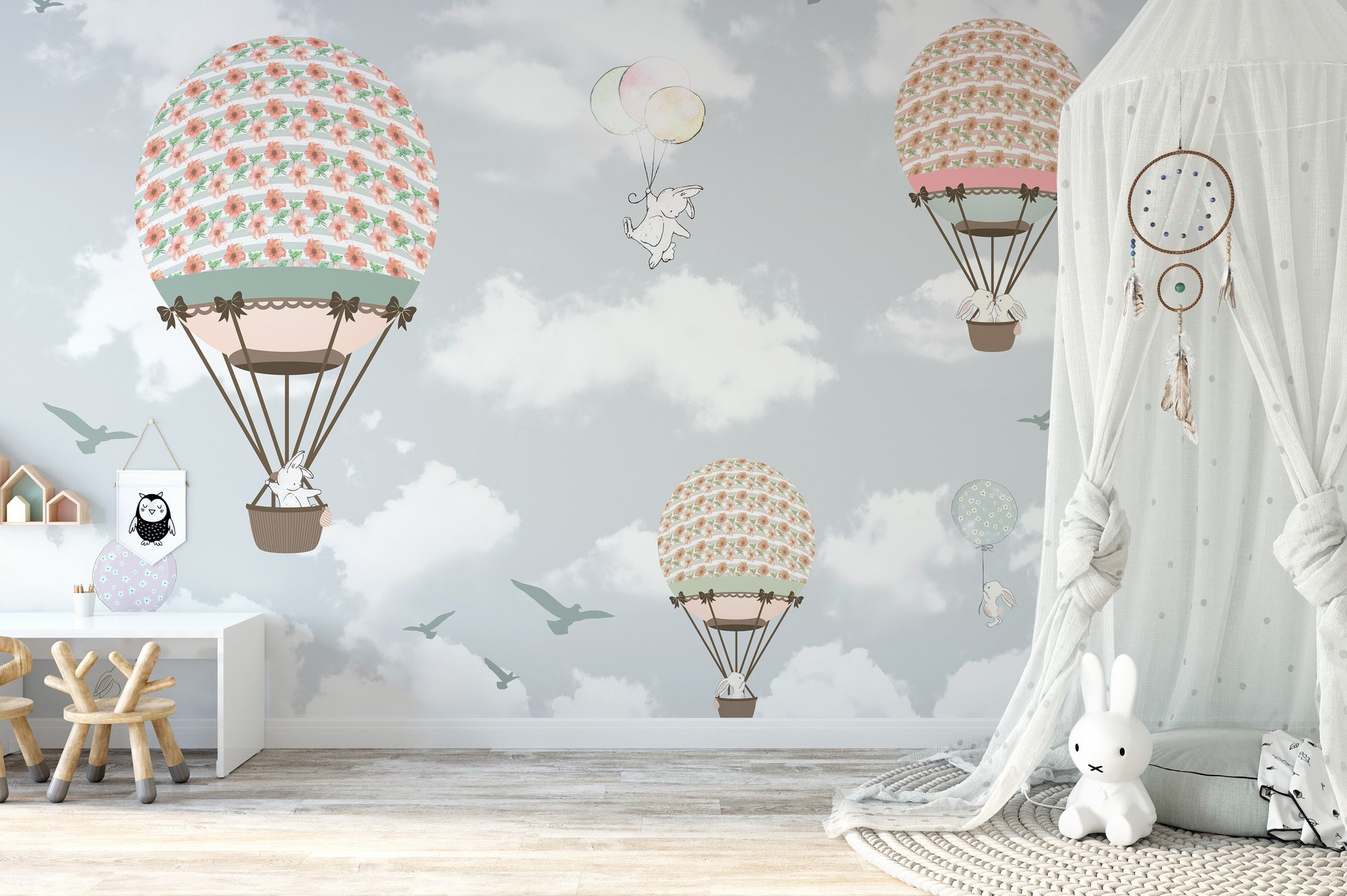 Animals on Balloons in the Sky wallpaper mural with pastel balloons and bunnies in a kids room with a canopy and bunny lamp