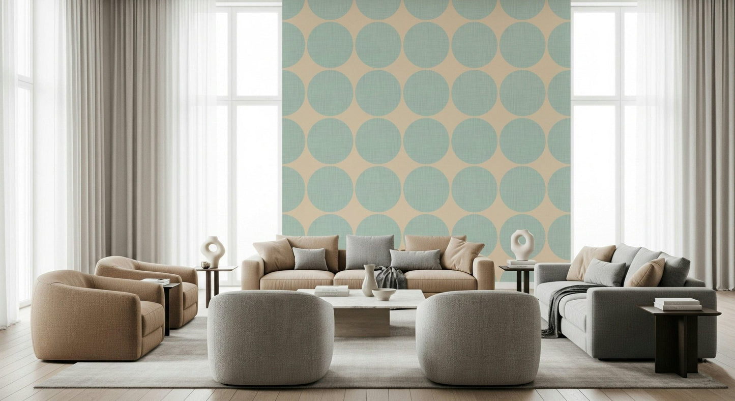 Beige wallpaper decorated with large aqua dots that display a soft fabric-like texture