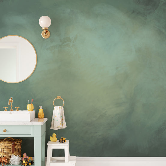 Aqua Stone Marble wallpaper mural in green behind a mint vanity with a round gold mirror in a kids bathroom