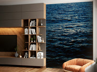 A peaceful mountain range mural on decorative wallpaper.

