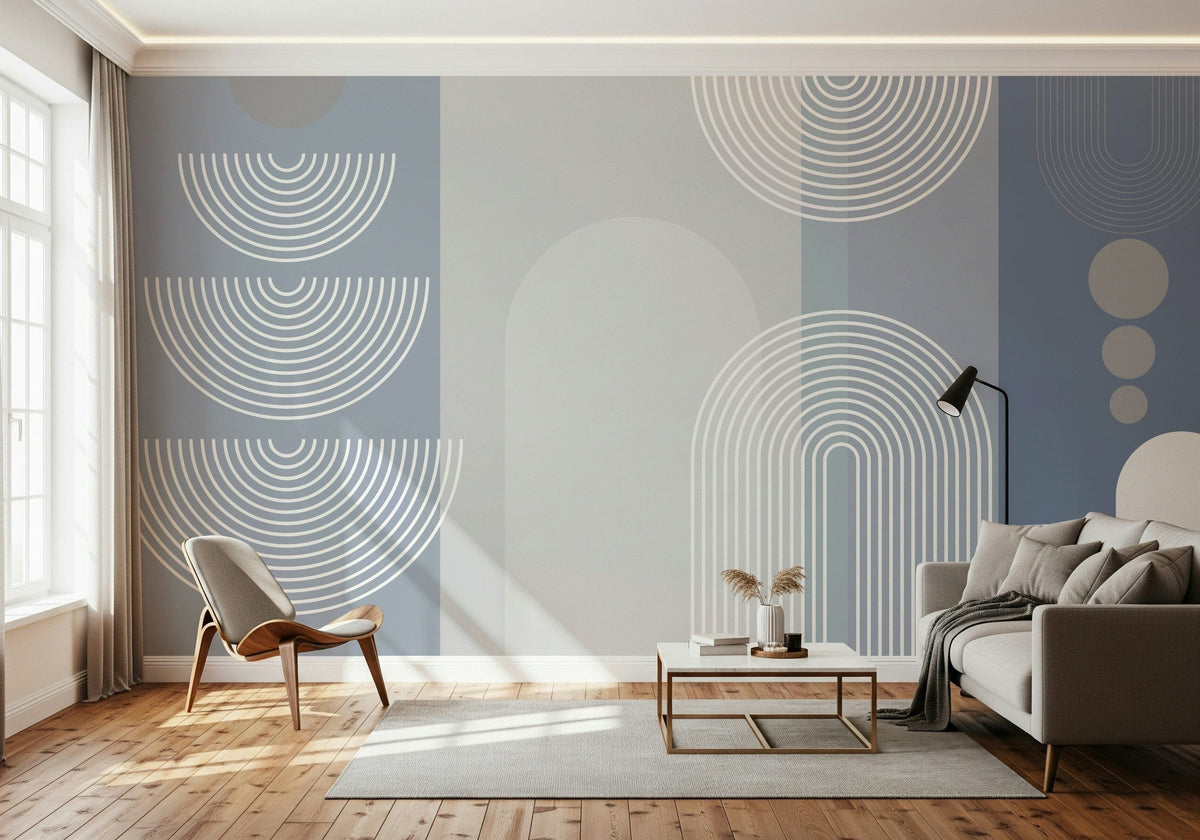 Arcane Geometry wallpaper mural in blue-grey arches behind a grey sofa and wishbone chair in a living room