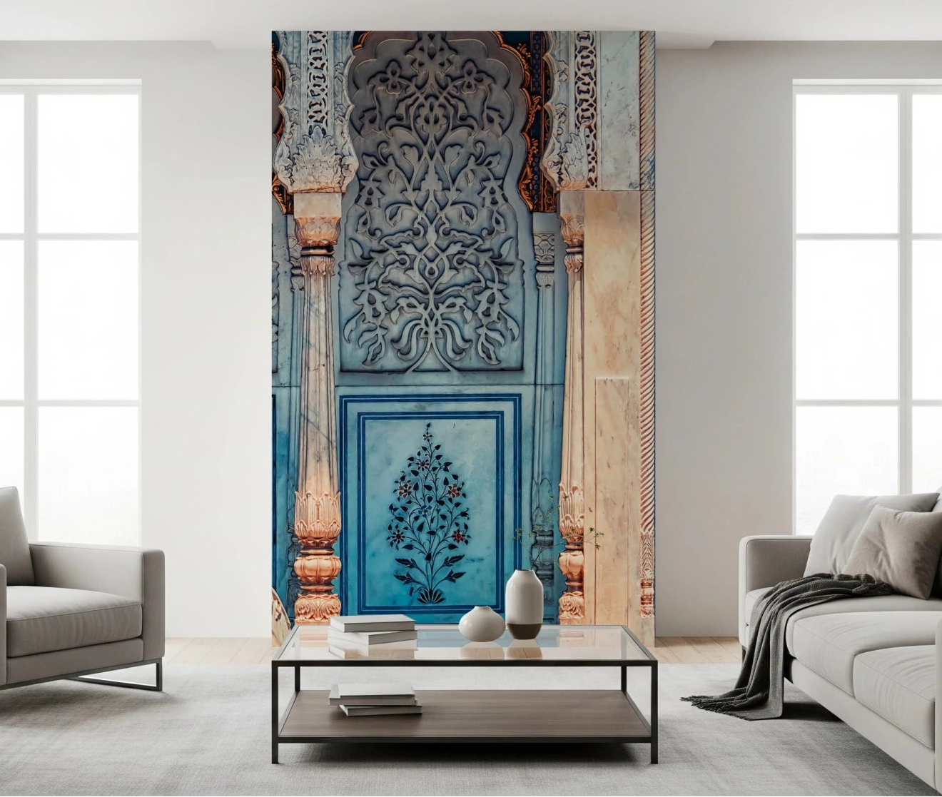 Archway Blossom wallpaper mural of carved blue Mughal arches behind a gray sofa and black coffee table in a living room