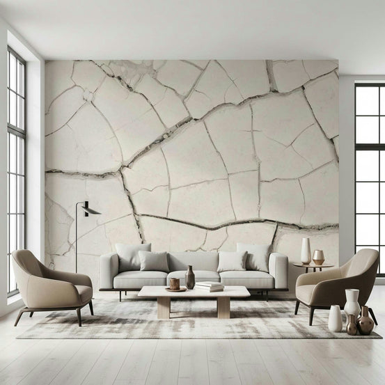 Arid Earth Abstract wallpaper mural of cracked cream plaster behind a grey sofa and beige armchairs in a living room