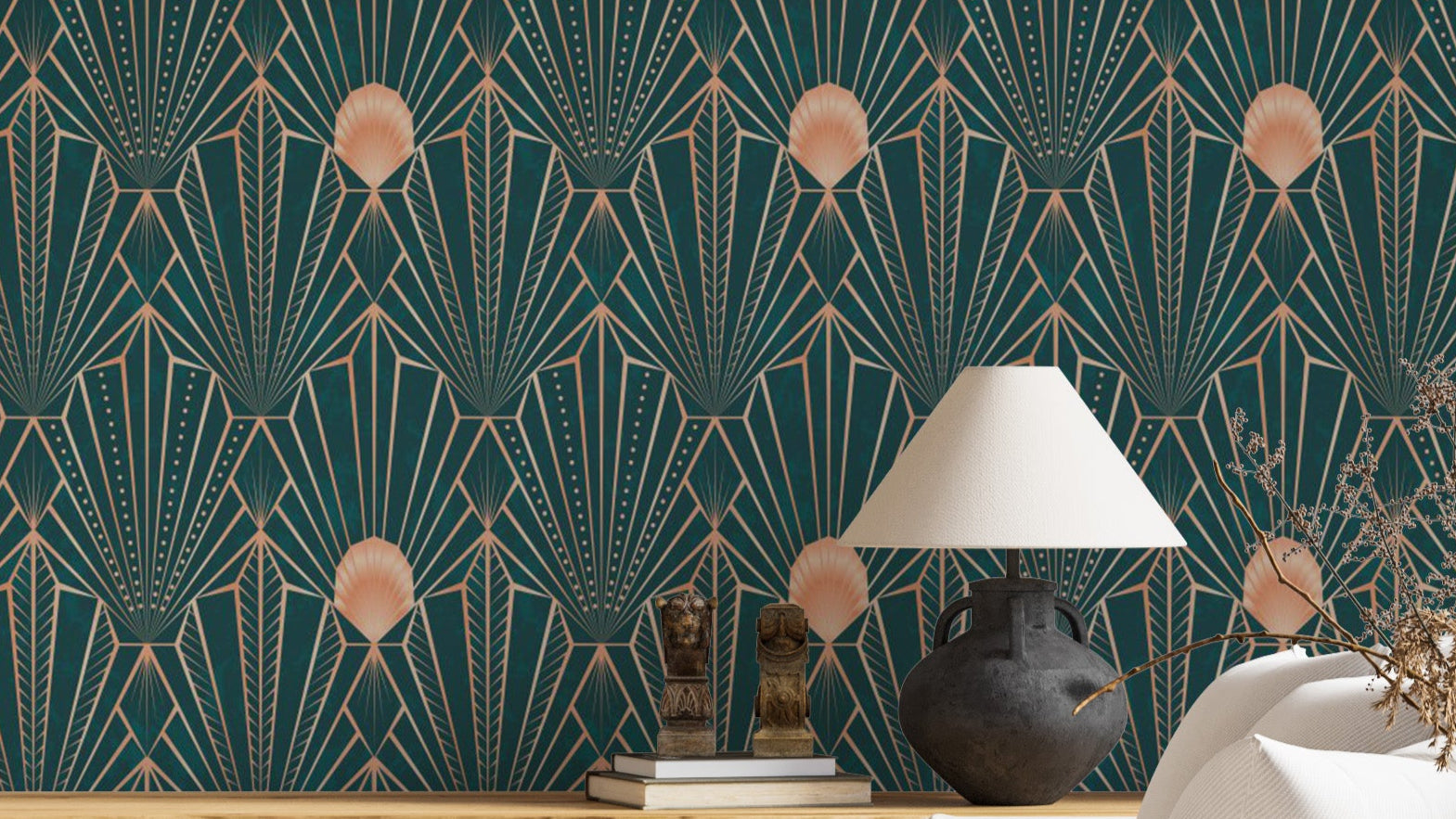 Art Deco Teal and Rose Gold Geometric wallpaper behind a console with a black lamp and brass bookends