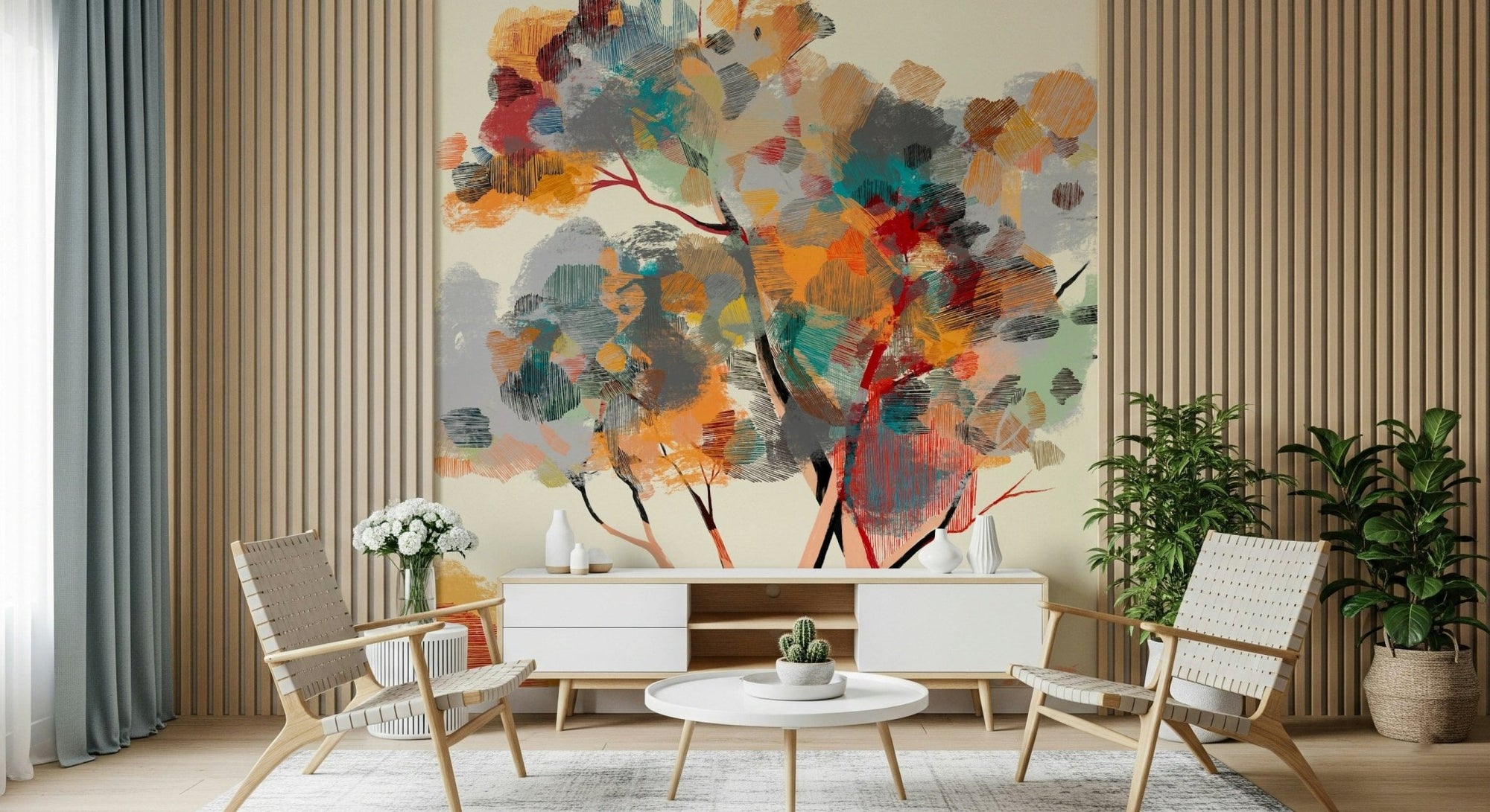 Autumn Tree wallpaper mural in painterly orange and teal behind a white console and wood chairs in a living room