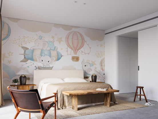 Baby Elephant Sky Adventure mural with pastel elephants in hot air balloons above an upholstered bed