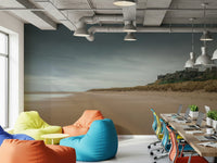 Coastal castle wall mural above modern sofa