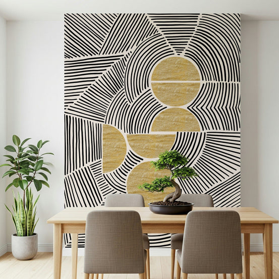 Bauhaus Tribal wallpaper mural in black-and-white lines with gold discs behind a wood dining table