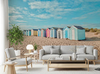 Blue and yellow beach huts wall mural for office area coastal wall decor.