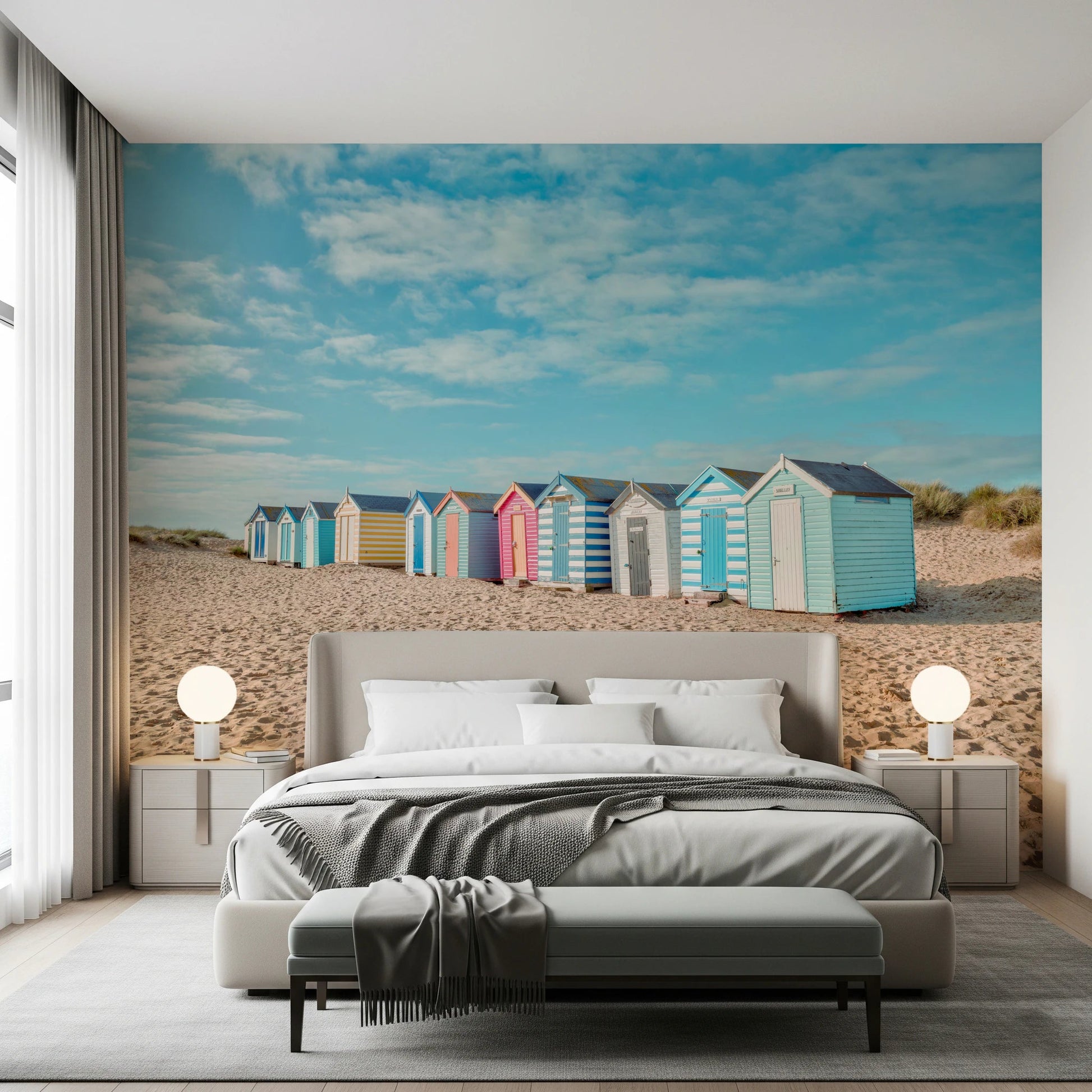 Soft pink and blue beach huts wall mural for bedroom on a sandy shore.