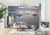 Beach Twilight Wall Mural behind sofa, calm shoreline scene, muted color palette, modern style