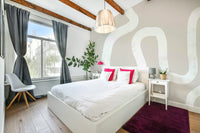 A beautiful modern art wall mural of a winding road.

