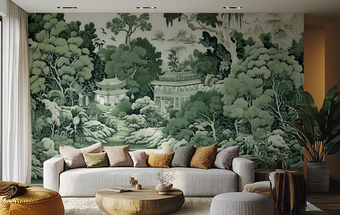 Green Garden wallpaper mural of green chinoiserie trees, pagodas and a lake behind a white sofa and wood coffee table