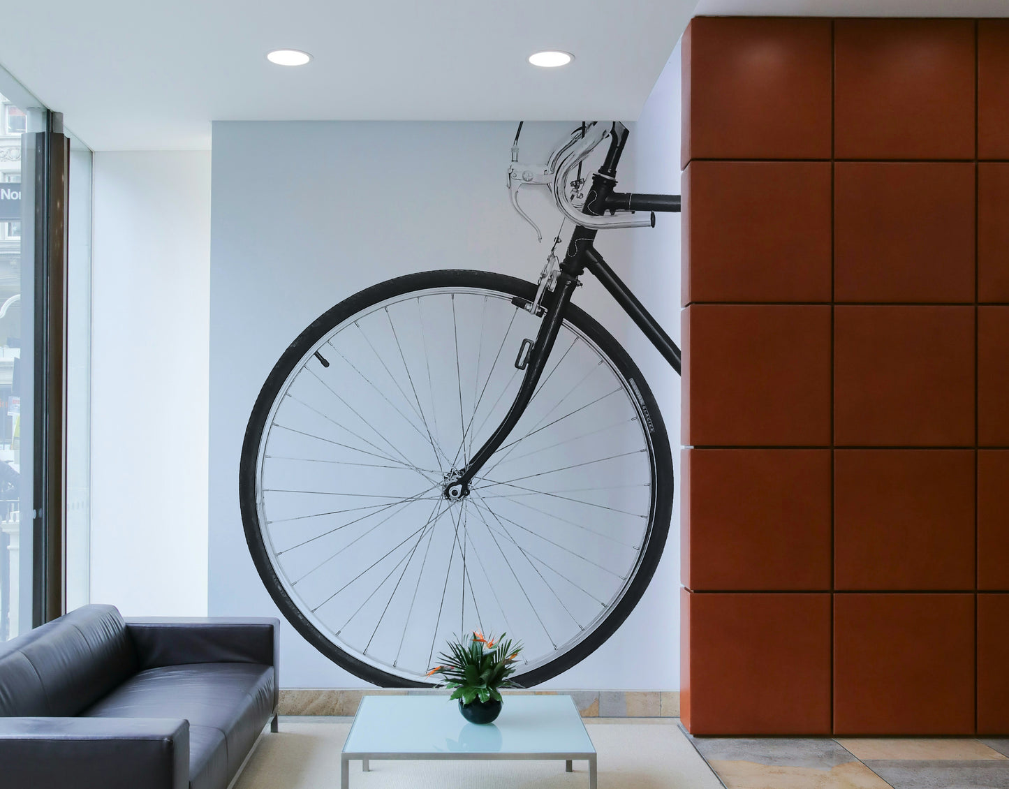 White wall with bicycle mural in soft colours

