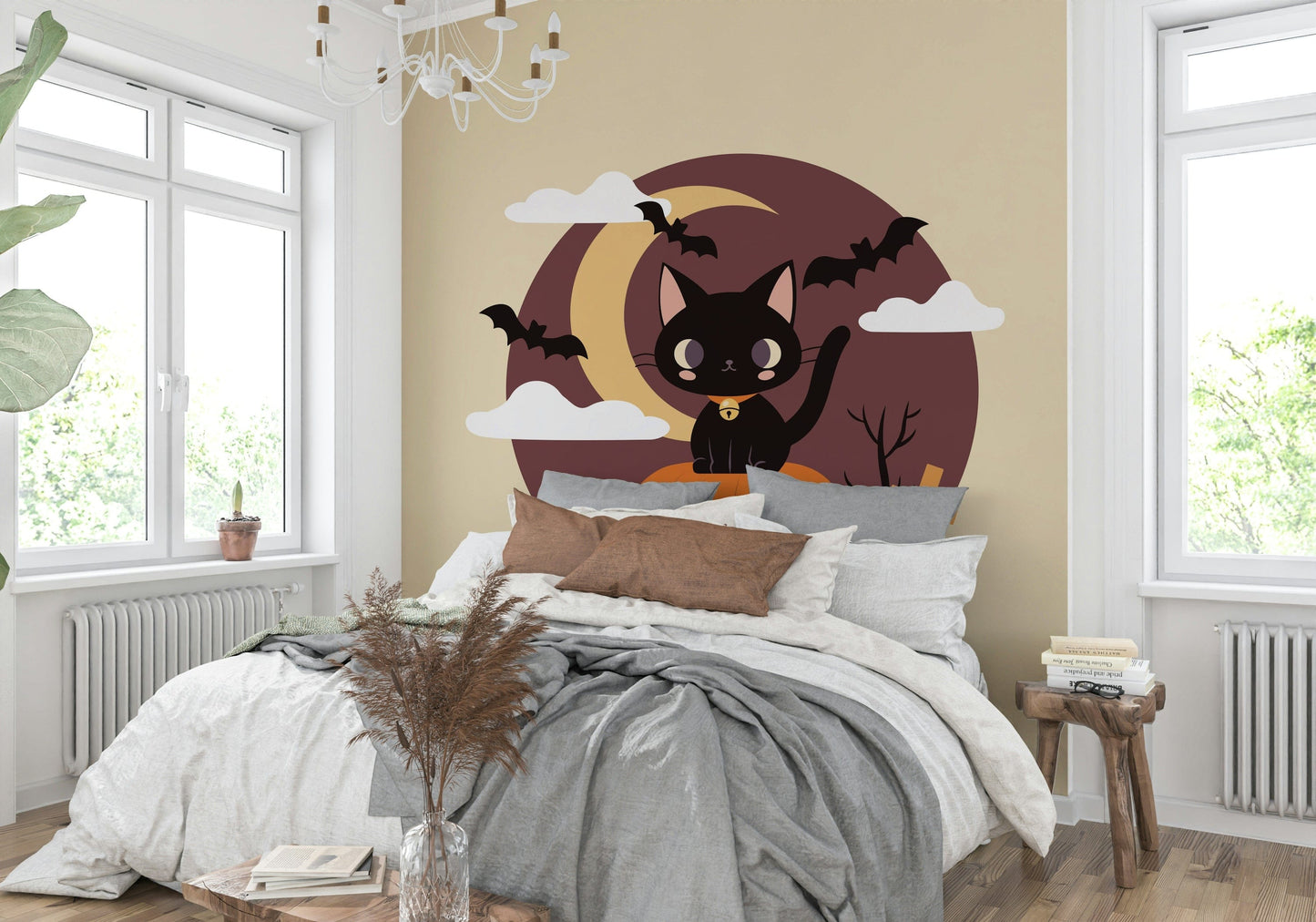 A black cat sitting on a pumpkin mural under a full moon with bats.
