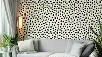 Chic black polka dot wallpaper with a hand-painted feeling.
