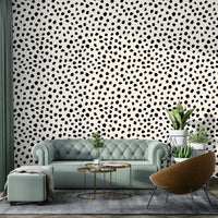Playful black and white wallpaper featuring irregular dots.

