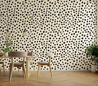 Minimalist speckled pattern wallpaper in black and neutral.
