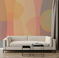 A soft abstract wallpaper featuring overlapping translucent ovals in warm pastel tones.