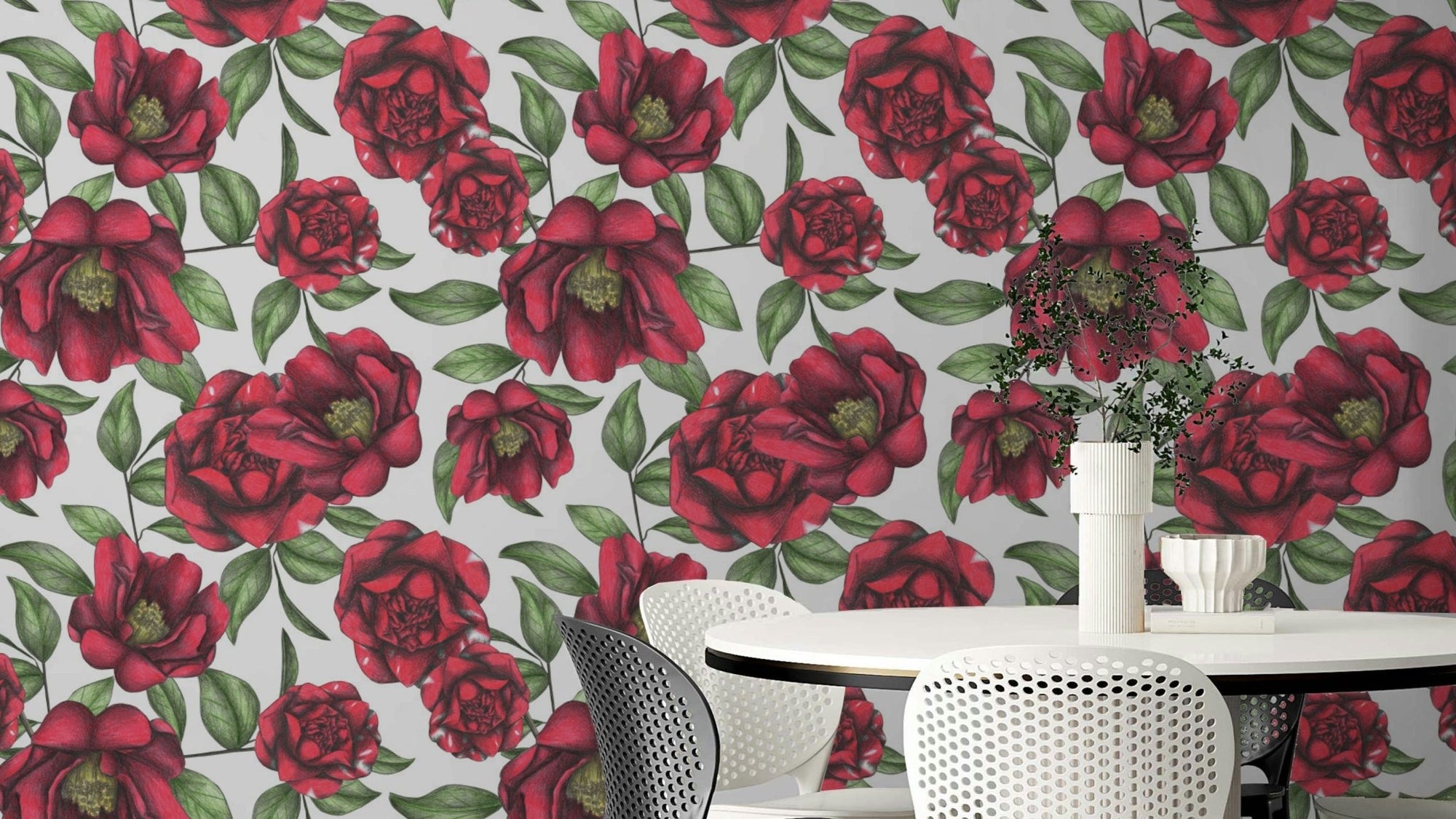 Blooming Camellias wallpaper mural with red camellia flowers and green leaves above a white round dining table and chairs