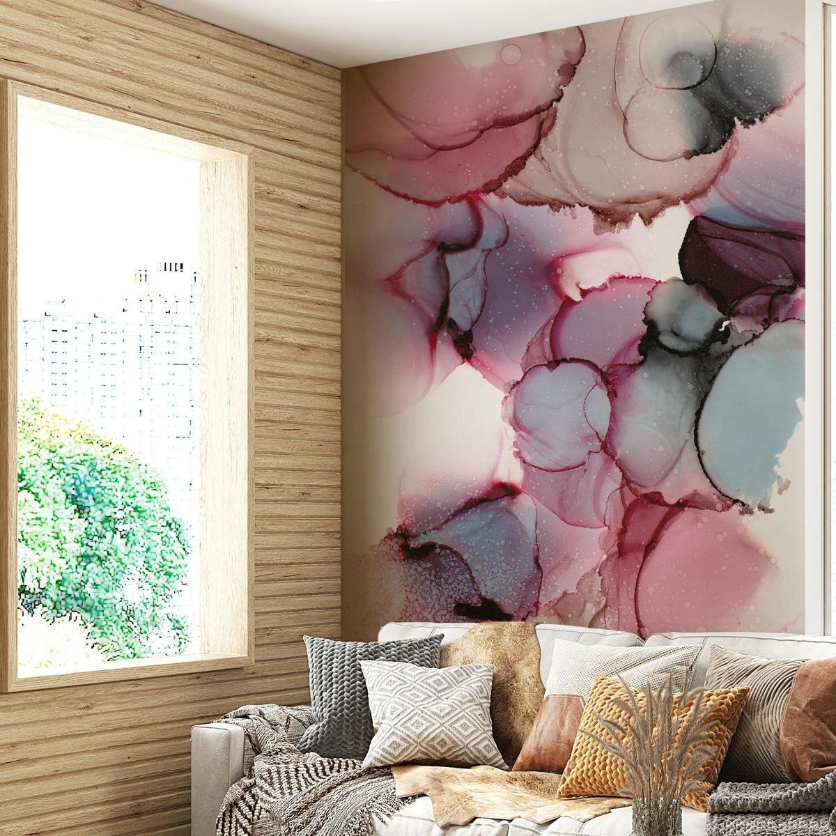 Blossom Fluidity wallpaper mural of pink, blue and black ink art beside a wood window above a grey sofa in a living room