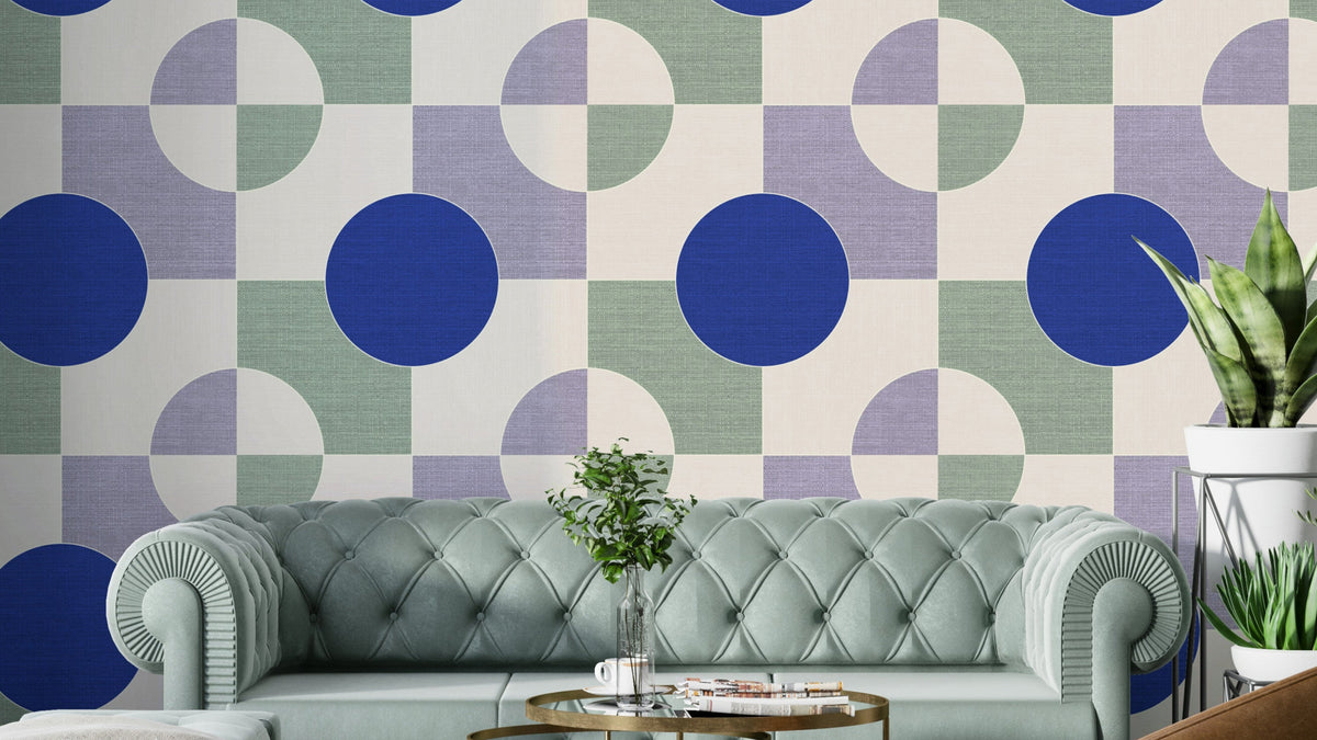 Blue Circle Canvas wallpaper mural with cobalt circles on a sage grid behind a sage tufted sofa