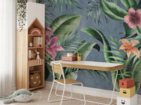 Blue background mural with large green floral leaves design.
