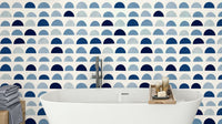 A modern wall mural with a repeating pattern of half-moon shapes.

