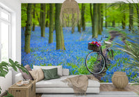 Striking Bluebell Carpet forest, solitary bike waiting on muddy path.