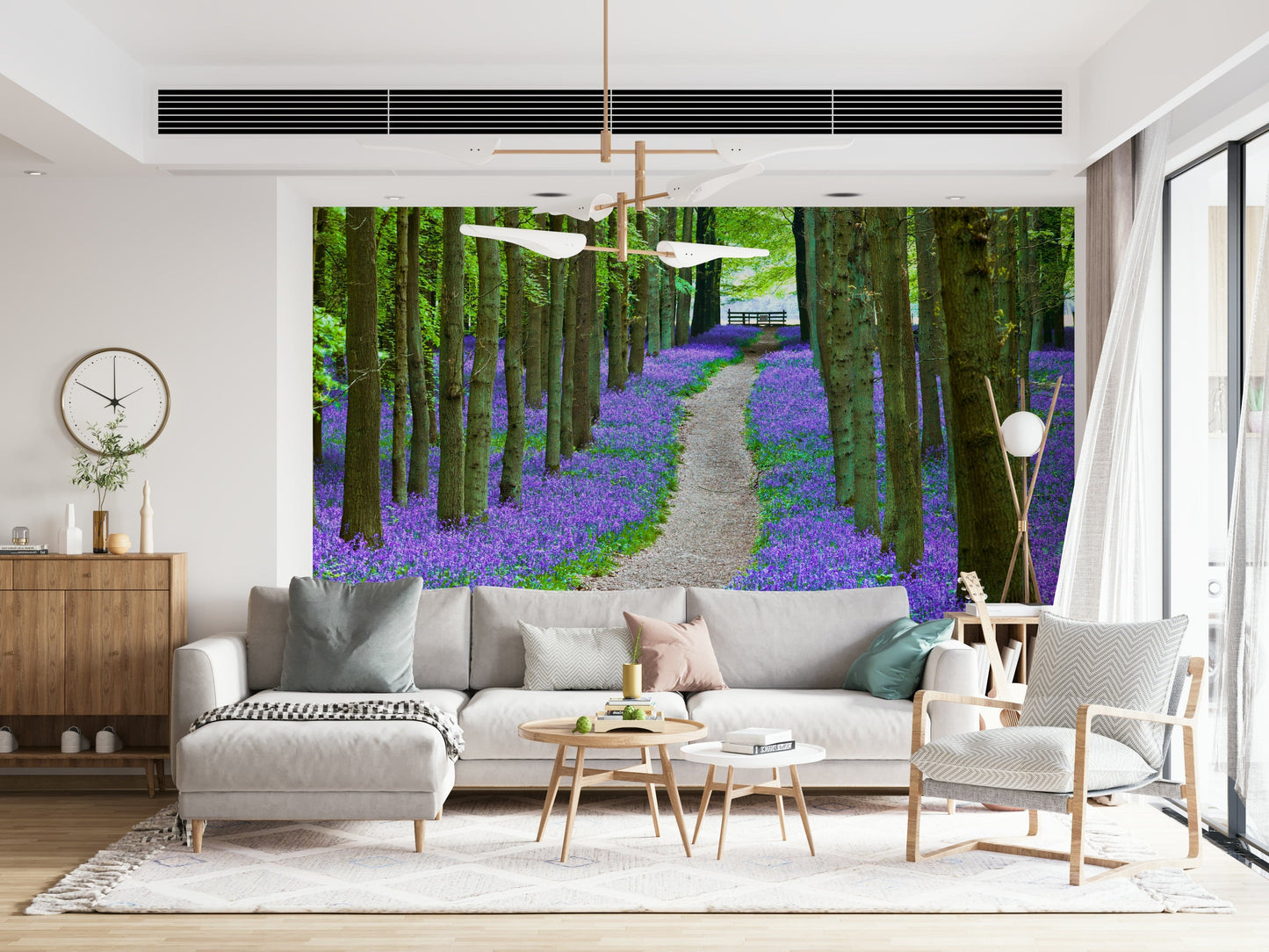 Nature wallpaper with tall forest trees and a carpet of purple-blue bluebells along a peaceful path.